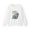 White crewneck sweatshirt with cozy armchair and pillows graphic and "Cozy up for Winter" text design